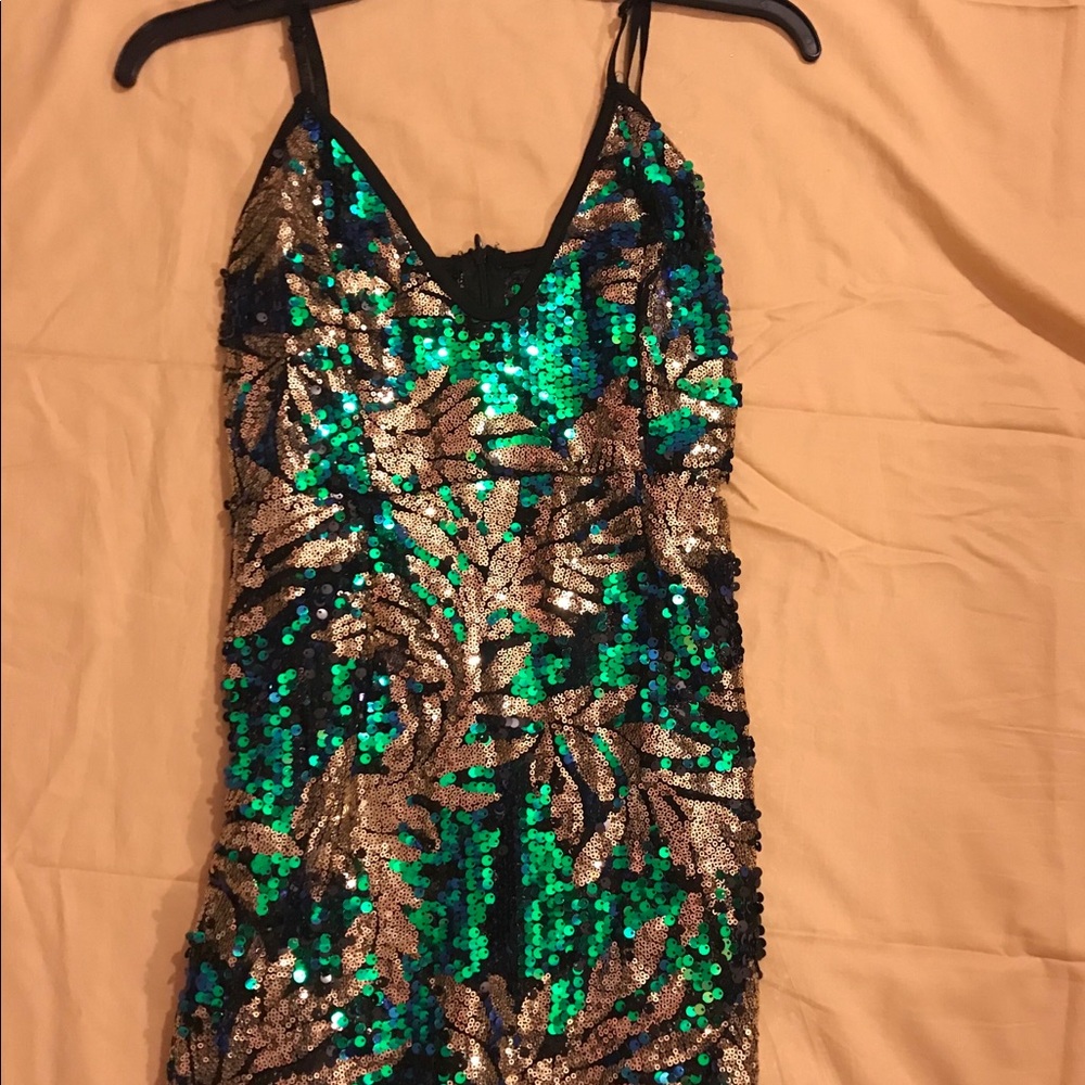 Green and gold sequin dress .
